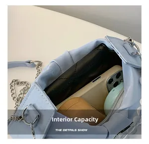 Top view showing internal capacity of the light blue pleated bag with silver chain