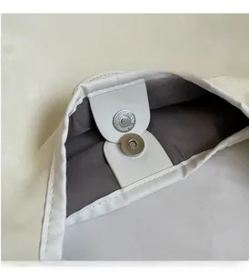 Détail de la fermeture magnétique argentée sur cabas blanc avec doublure en tissu gris