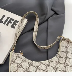 Dettaglio della borsa hobo a mezzaluna con stampa a quadrifoglio e cerniera dorata