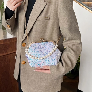 Sparkly sequin crossbody bag with pearl handle and golden kiss-lock closure for women
