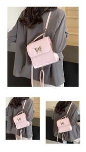 Detail of pink vintage-style backpack with gold butterfly buckle and pleated texture