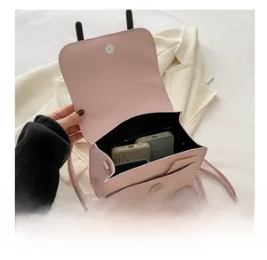 Pink PU leather backpack interior showing capacity for two smartphones and cards