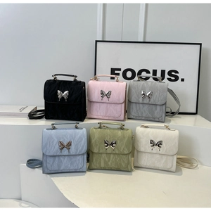Matrix view of pleated fabric backpacks in six colors with silver butterfly metal buckles