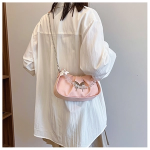 Pink pleated crossbody bag with metal chain and transparent beaded handle detail
