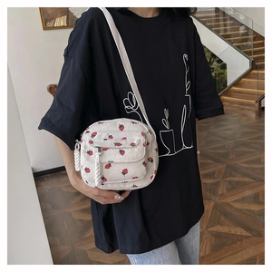 Minimalist white corduroy crossbody bag with red berry print for women in casual style