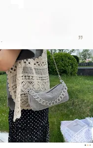 Detailed view of silver rhinestone handbag with elegant chain strap and sparkling finish