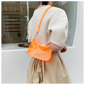 Vibrant orange transparent PVC shoulder bag featuring a sleek rectangular design with metal strap hooks
