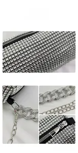 Macro details of silver rhinestone bag featuring dense crystal mesh and dual metal chain straps