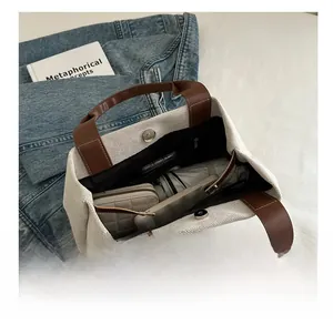 Spacious canvas tote bag interior showing capacity for umbrella, phone and wallet