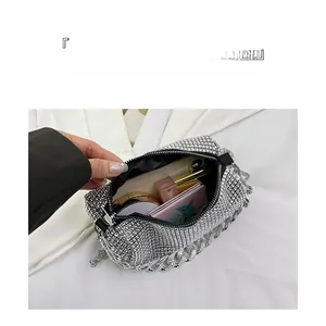 Detailed interior view of silver rhinestone crossbody bag showing large storage capacity