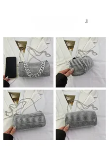 Detail view showing silver rhinestone cylinder bag with metallic chain straps and phone size