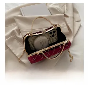 Interior view of burgundy velvet bag showing capacity for phone and cosmetics