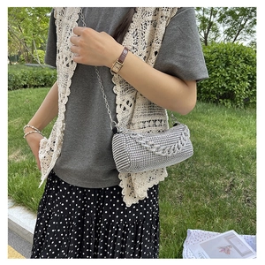 Detail of silver rhinestone cylinder crossbody bag with elegant metal chain strap