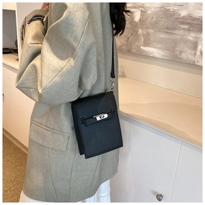 Chic black vertical leather phone bag for women featuring a silver twist lock buckle
