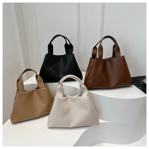 Woven texture tote bags in four colors displayed on geometric steps in a studio setting