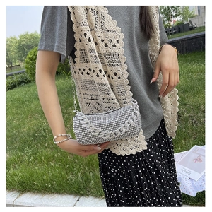 Detailed view of shimmering silver rhinestone clutch with thick decorative chain strap