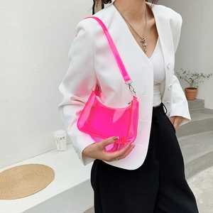 Neon pink translucent PVC half-moon shoulder bag styled with a white blazer