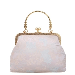 Borsa a mano in seta jacquard rosa con manico dorato circolare e motivo retrò orientale