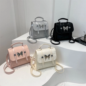 Mini multi-color leather backpacks with butterfly hardware in silver, black, pink, white