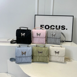 Mini nylon backpack with pleated texture and metal butterfly buckle in six pastel colors