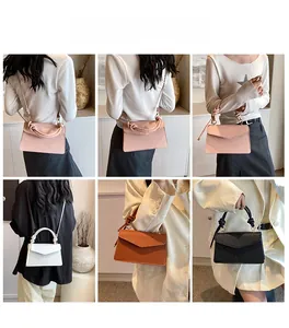 Close-up of stylish faux leather envelope handbag showing knot handle detail and colors