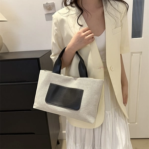 Contrast canvas tote bag with black leather pocket and handles for casual daily style