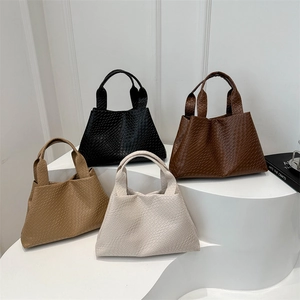 Large woven tote bags set in black, coffee, khaki, and cream on a minimalist stand