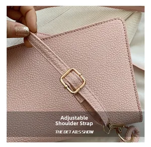 Detail of adjustable pink pebbled leather strap with polished gold metal buckle