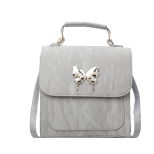Silver wrinkled texture crossbody bag with a metallic butterfly buckle on white background