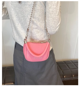 Pink mini saddle bag featuring lychee texture leather and a silver metal beaded chain