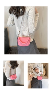 Detail of pink lychee leather crossbody bag with metal chain strap and top handle