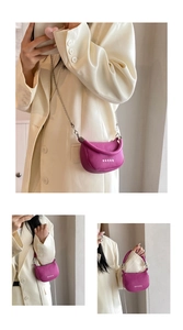 Magenta half-moon mini bag with white star pattern and silver chain strap detail