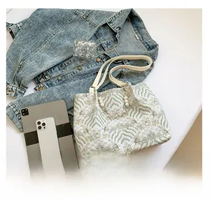Close-up of retro wave print tote bag with elegant pearl and metal chain decoration