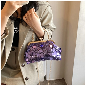 Macro shot of purple sequin evening bag featuring gold metal handle and chain link strap