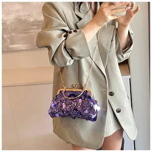 Detail of purple sequin shell bag with vintage gold heart clasp and chain strap