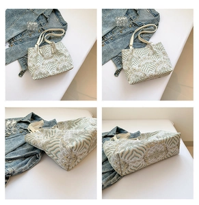 Detail view of tote bag with floral jacquard pattern and pearl chain ornament