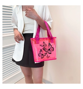 Pink transparent PVC tote bag with black butterfly print and durable woven handles