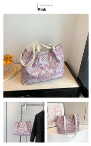 Close-up of pink wave pattern embroidery fabric and pearl chain on a bamboo handle tote