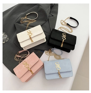 Flat lay showing four colorful crossbody bags with gold SS hardware and stylish tassels
