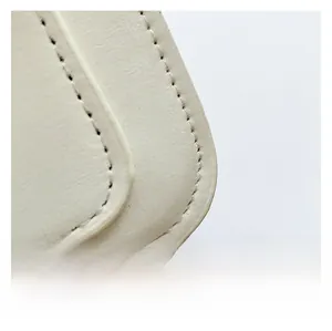 Close-up of premium cream leather texture and precise stitching on the Cambridge bag
