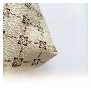 Close-up of vintage floral print on premium lychee-textured faux leather fabric