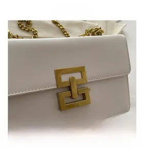Close-up of white faux leather texture with vintage brushed gold geometric buckle