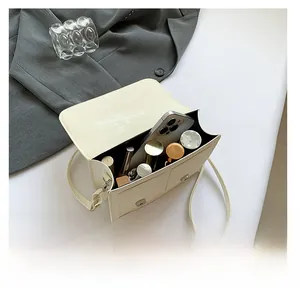 Top view showing bag interior space for smartphone, lipsticks and cosmetics