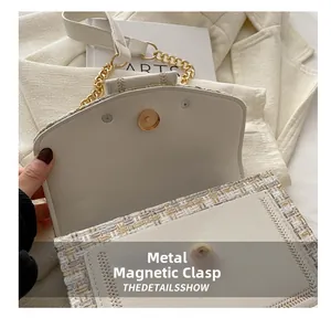 Detail view of the gold magnetic closure and interior of the tweed chain shoulder bag