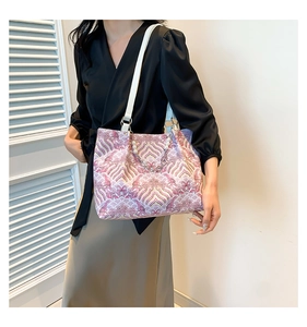 Detail of colorful wave pattern tote bag with pearl chain and white leather strap