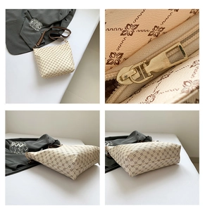 Detail view of printed crossbody bag showing floral pattern, base, side and interior zipper