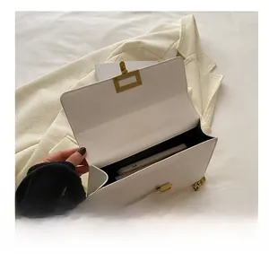 Interior view of white leather shoulder bag showing storage capacity for a smartphone