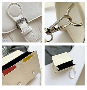 Detail view of beige Cambridge bag showing dual inner compartments and gold stitching