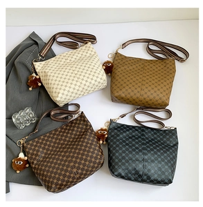 Detail of four vintage floral bucket bags with wide striped straps and cute plush charms