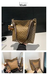 Detail of khaki bucket bag with floral monogram print and striped wide shoulder strap